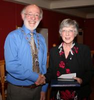 President Gordon Sanders presents Margaret Young with the Paul Harris Fellowship which was awarded to the late David Young shortly before he passed away.
